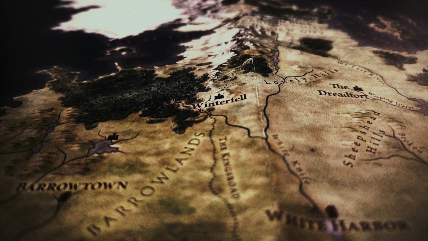 Stylized fantasy map with locations like Winterfell and The Kingsroad.